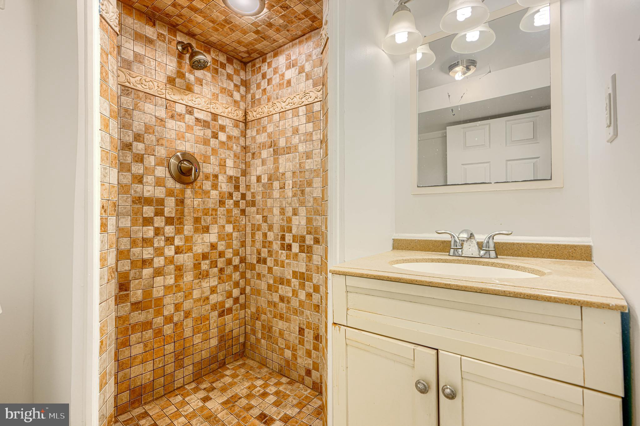 30 Portship Road Baltimore, MD 21222 - Photo 25 of 33 a bathroom with a sink vanity granite and a mirror
