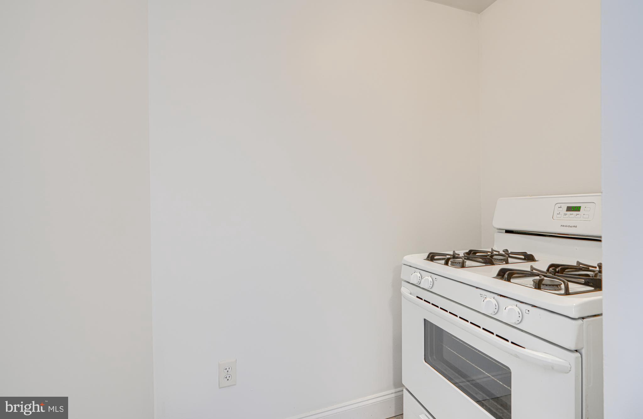 30 Portship Road Baltimore, MD 21222 - Photo 10 of 33 a white stove top oven sitting inside of a kitchen