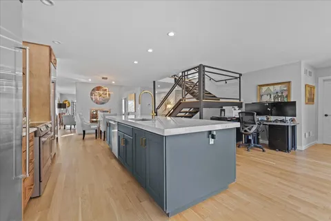 a kitchen with stainless steel appliances granite countertop a stove and a sink
