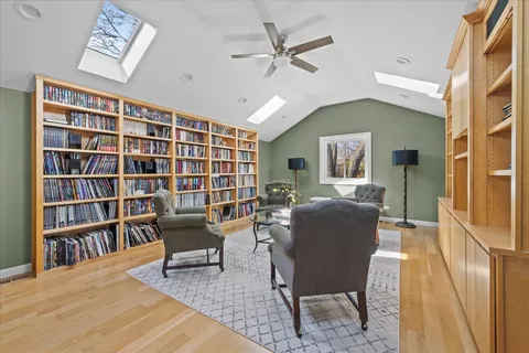 a living room with furniture and a book shelf