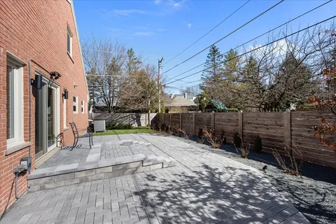 a view of a backyard with wooden fence