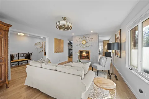 a living room with furniture a fireplace and a large window