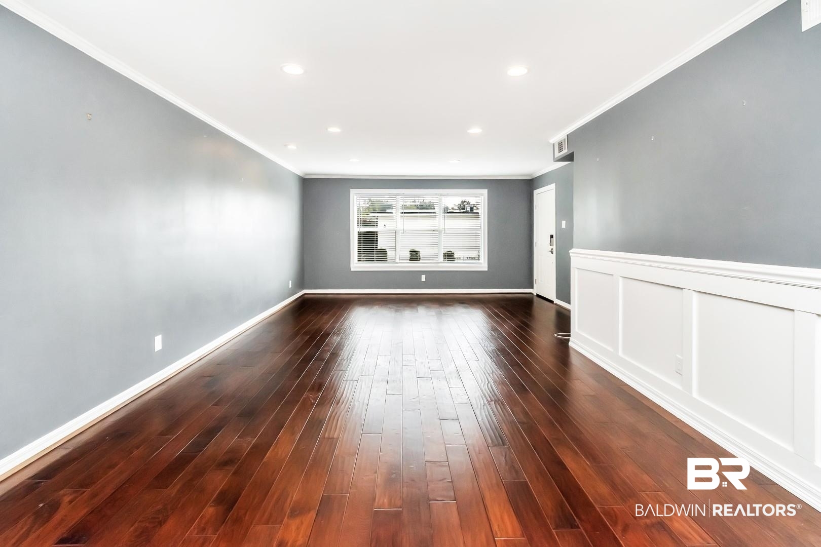 4009 Old Shell Road, Unit E24 Mobile, AL 36608 - Photo 6 of 19 Empty room featuring crown molding and dark wood-type flooring