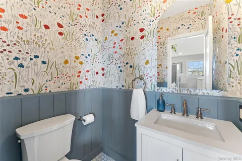 a bathroom with a sink toilet and mirror