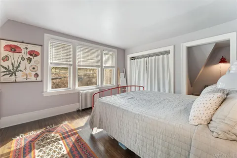 a bedroom with a bed and a large window