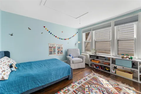a bedroom with furniture and a large window