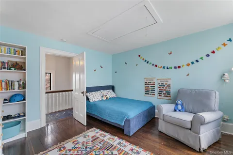 a bedroom with furniture and a book shelf
