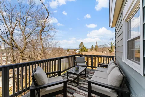 a view of a city from a balcony with furniture