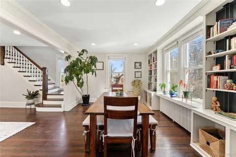 a dining room with furniture and wooden floor