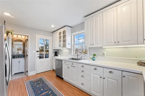 a kitchen with a sink window and cabinets