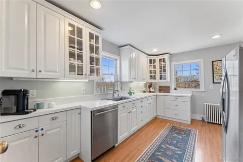 a kitchen with cabinets oven and wooden floor