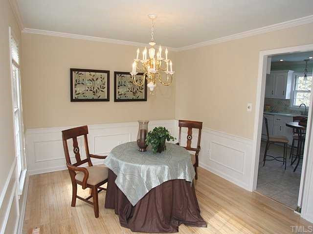 6808 Garrison Court Raleigh, NC 27613 - Photo 7 of 20 The dining room has wainscotting, hardwood floors and crown molding. Dining Room