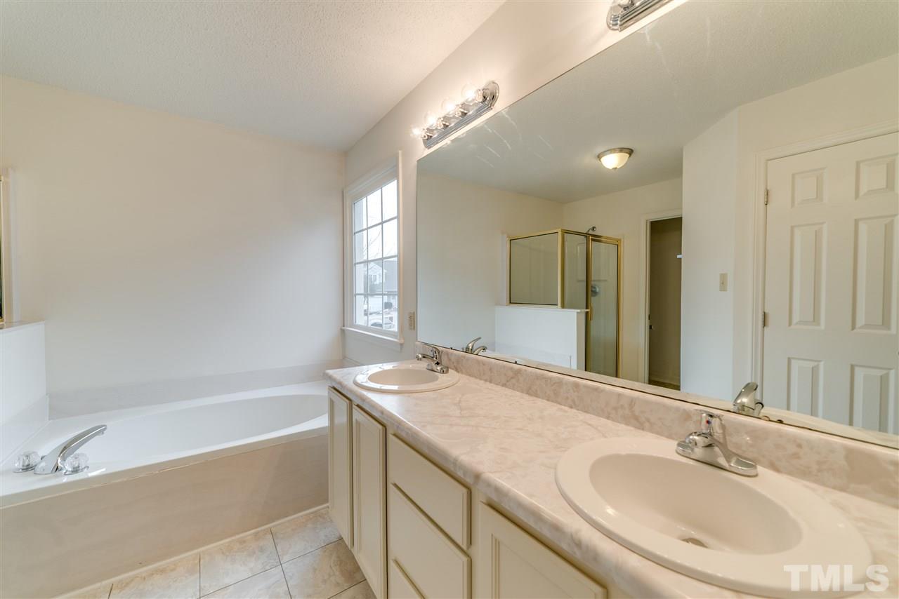 4213 Knightsbridge Way Raleigh, NC 27604 - Photo 15 of 23 a bathroom with a granite countertop sink mirror and a bathtub