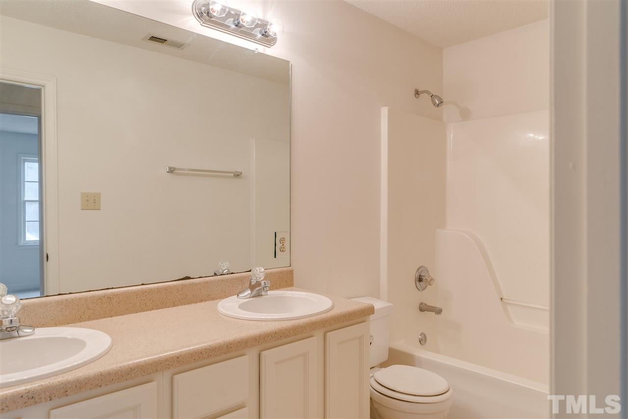 4213 Knightsbridge Way Raleigh, NC 27604 - Photo 18 of 23 a bathroom with a granite countertop sink toilet and shower