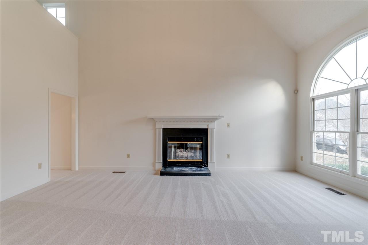 4213 Knightsbridge Way Raleigh, NC 27604 - Photo 4 of 23 an empty room with a window and fireplace