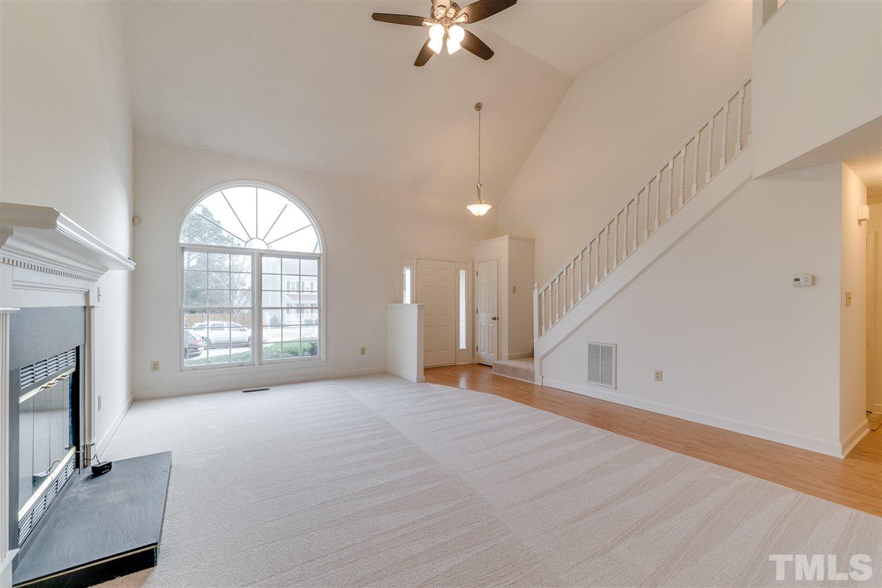 4213 Knightsbridge Way Raleigh, NC 27604 - Photo 5 of 23 a view of an empty room with a fireplace and a window