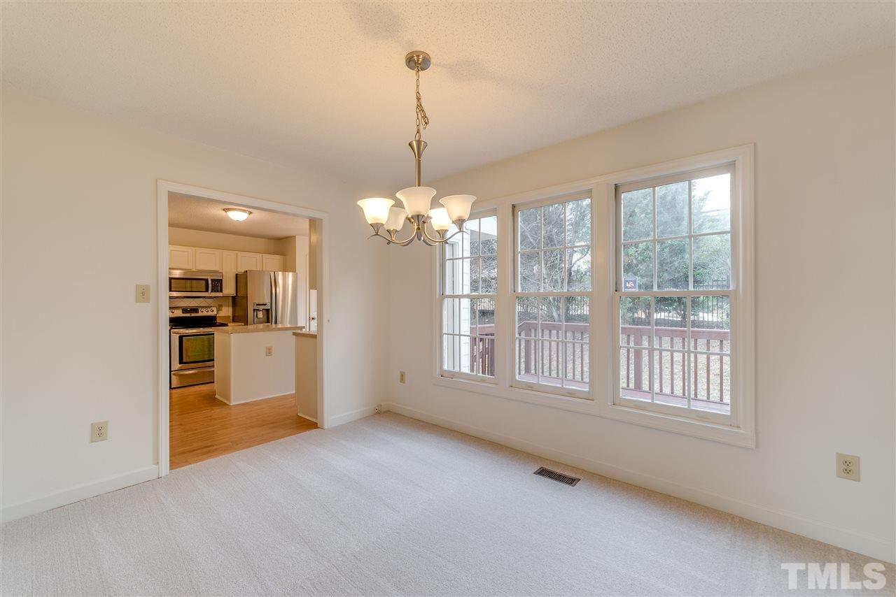 4213 Knightsbridge Way Raleigh, NC 27604 - Photo 6 of 23 a view of an empty room with kitchen and window