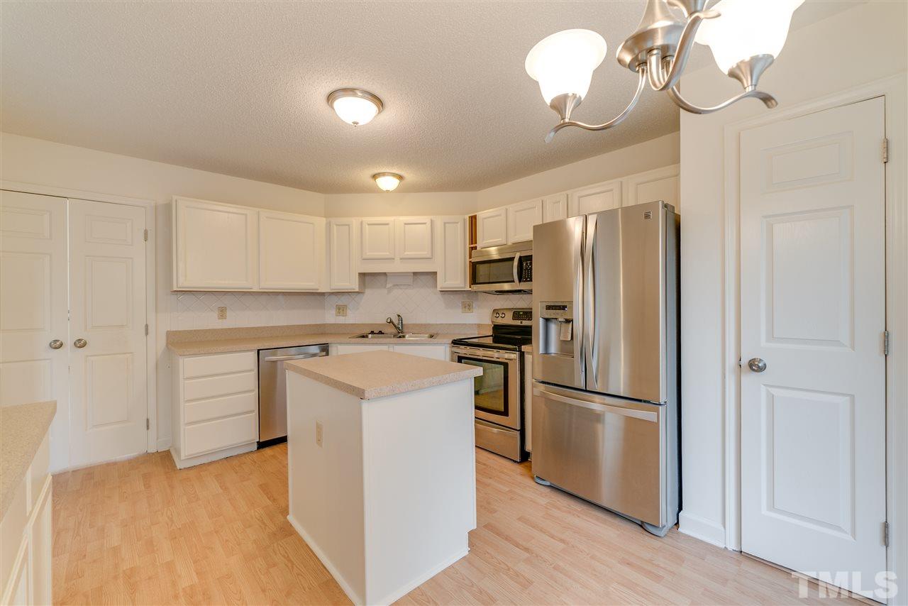 4213 Knightsbridge Way Raleigh, NC 27604 - Photo 8 of 23 a kitchen with cabinets stainless steel appliances and a window