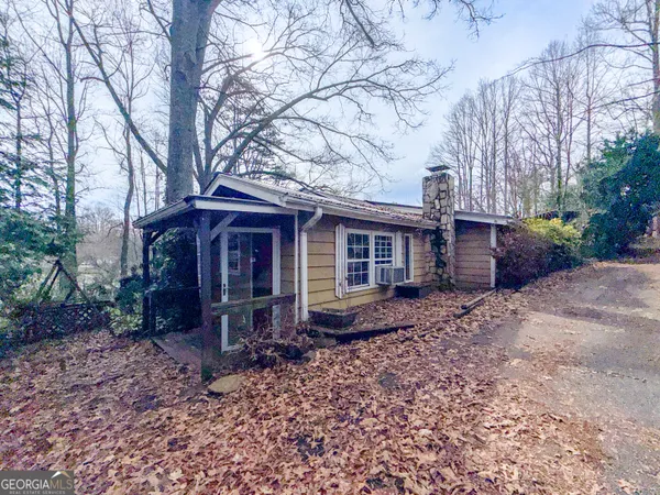 a view of a house with a yard and tree s