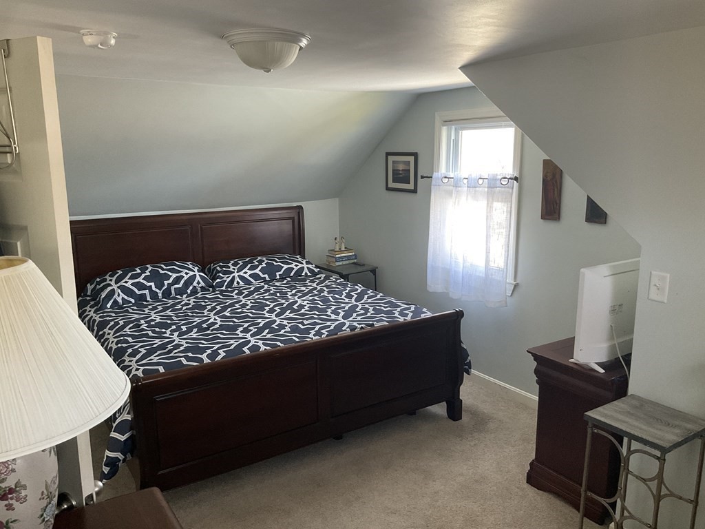 18 Ridgeway Street Dedham, MA 02026 - Photo 13 of 24 a bed sitting in a bedroom next to a window