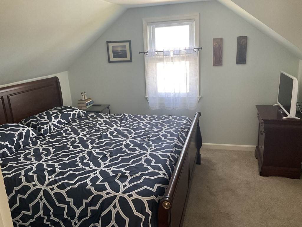 18 Ridgeway Street Dedham, MA 02026 - Photo 14 of 24 a bedroom with a bed and a window