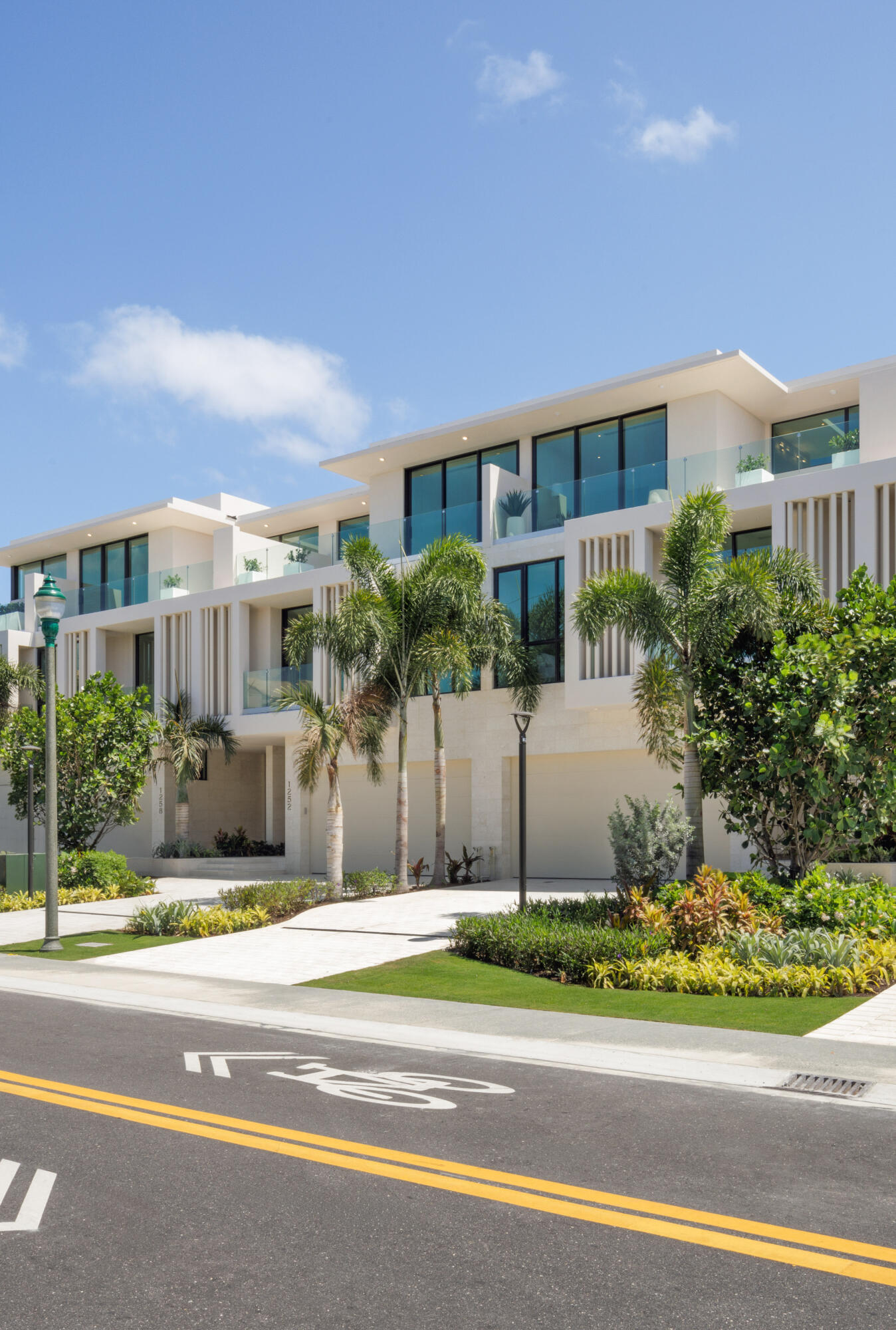 1246 George Bush Boulevard Delray Beach, FL 33483 - Photo 3 of 63 a front view of a house with a yard and potted plants