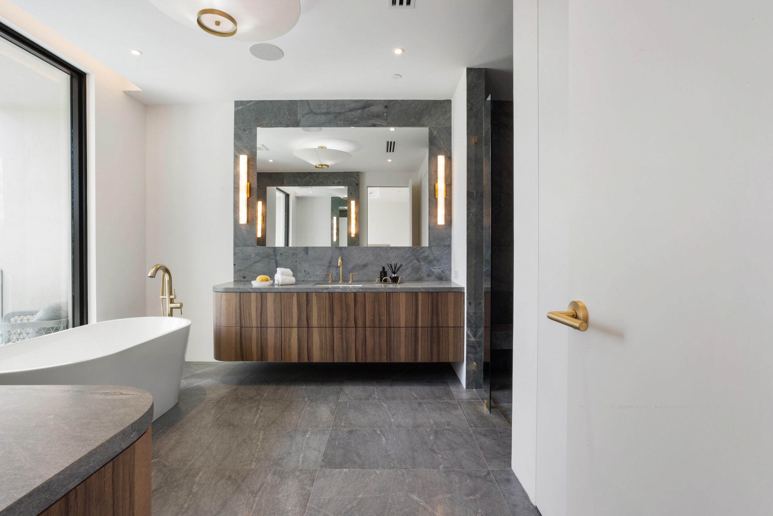 1246 George Bush Boulevard Delray Beach, FL 33483 - Photo 31 of 63 a bathroom with a tub a sink and mirror