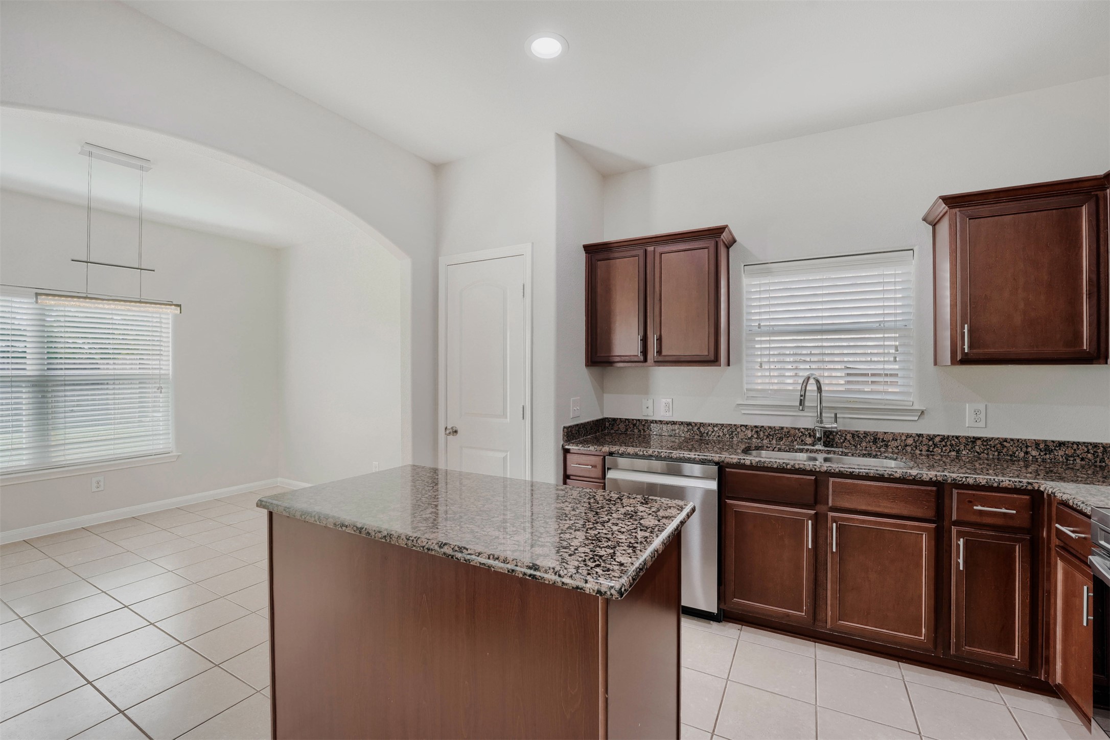 13408 Clara Martin Road Manor, TX 78653 - Photo 6 of 27 a kitchen with stainless steel appliances granite countertop a sink stove and cabinets