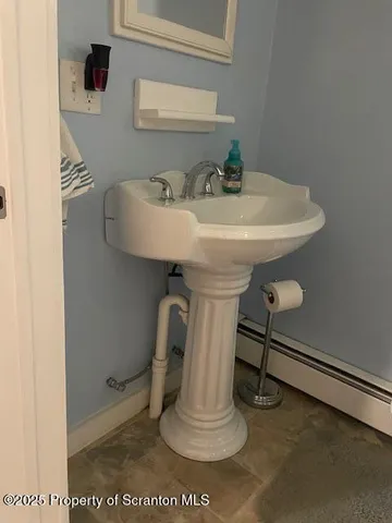 a white toilet sitting next to a shower
