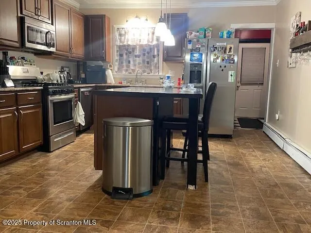 a kitchen with stainless steel appliances granite countertop a stove a refrigerator a sink a dining table and chairs