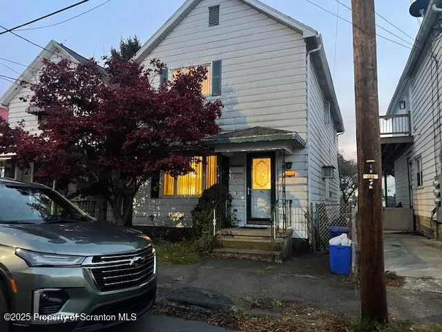 a view of a house with fountain and a tree