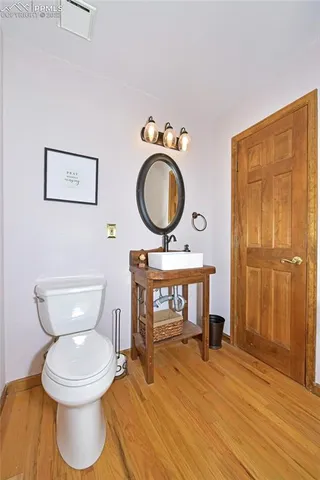 a bathroom with a toilet a sink and a mirror