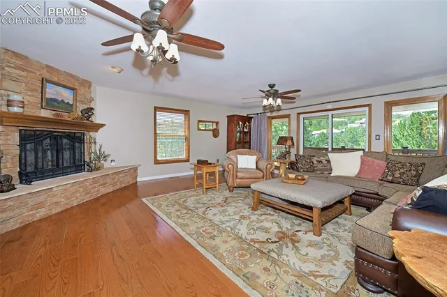 a living room with furniture a chandelier and a fireplace