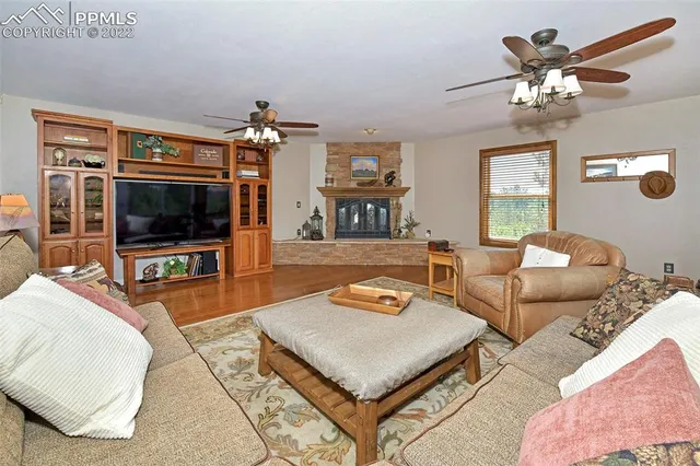 a living room with furniture a chandelier and a flat screen tv