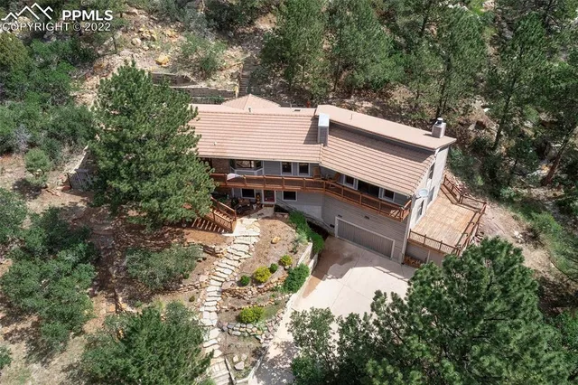 an aerial view of a house with a yard