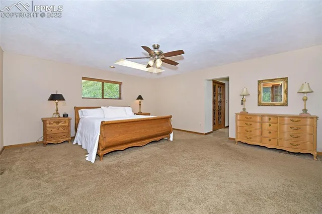 a bedroom with furniture and a ceiling fan