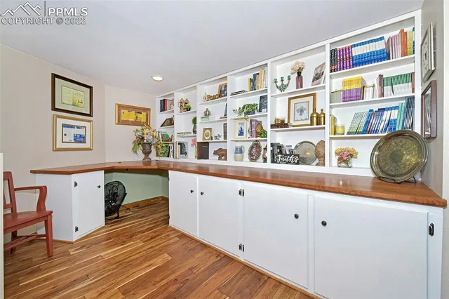 a kitchen with stainless steel appliances granite countertop a cabinets and a wooden floor