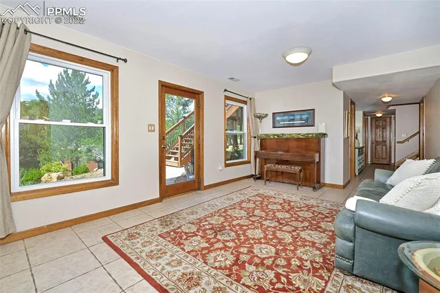 a living room with furniture a flat screen tv and a rug