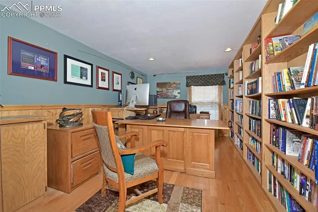 a living room with a couch and a book shelf
