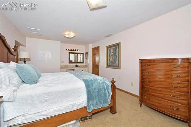 a bedroom with a bed and a dresser