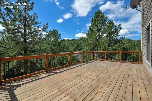 a view of balcony with wooden floor and fence