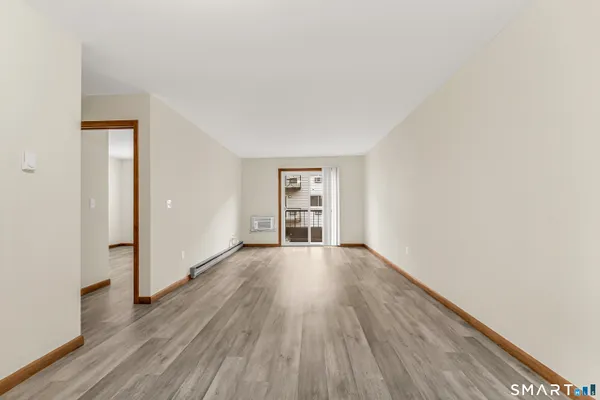 a view of an empty room with wooden floor