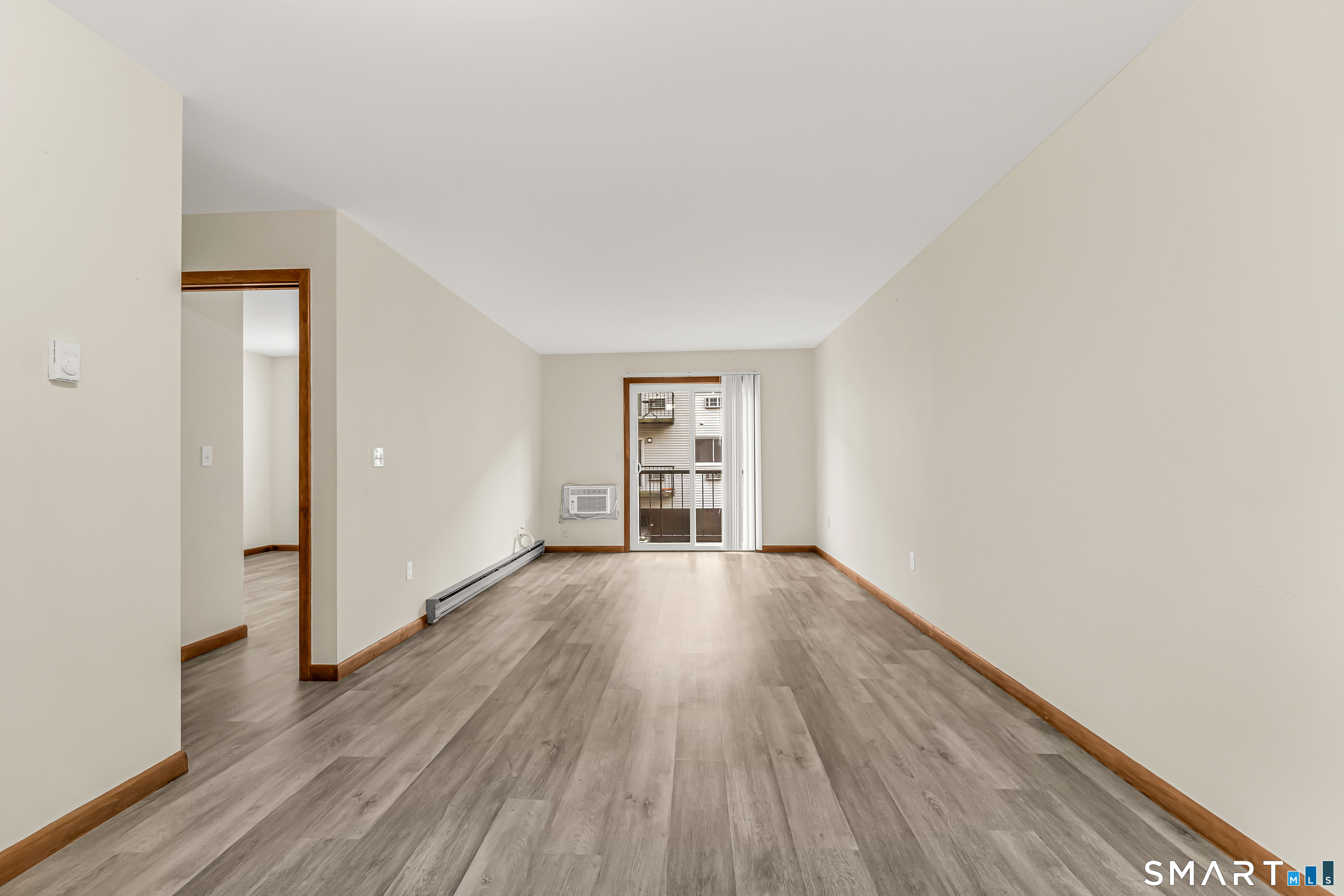 115 Short Beach Road, Unit 103 Stratford, CT 06615 - Photo 11 of 17 a view of an empty room with wooden floor