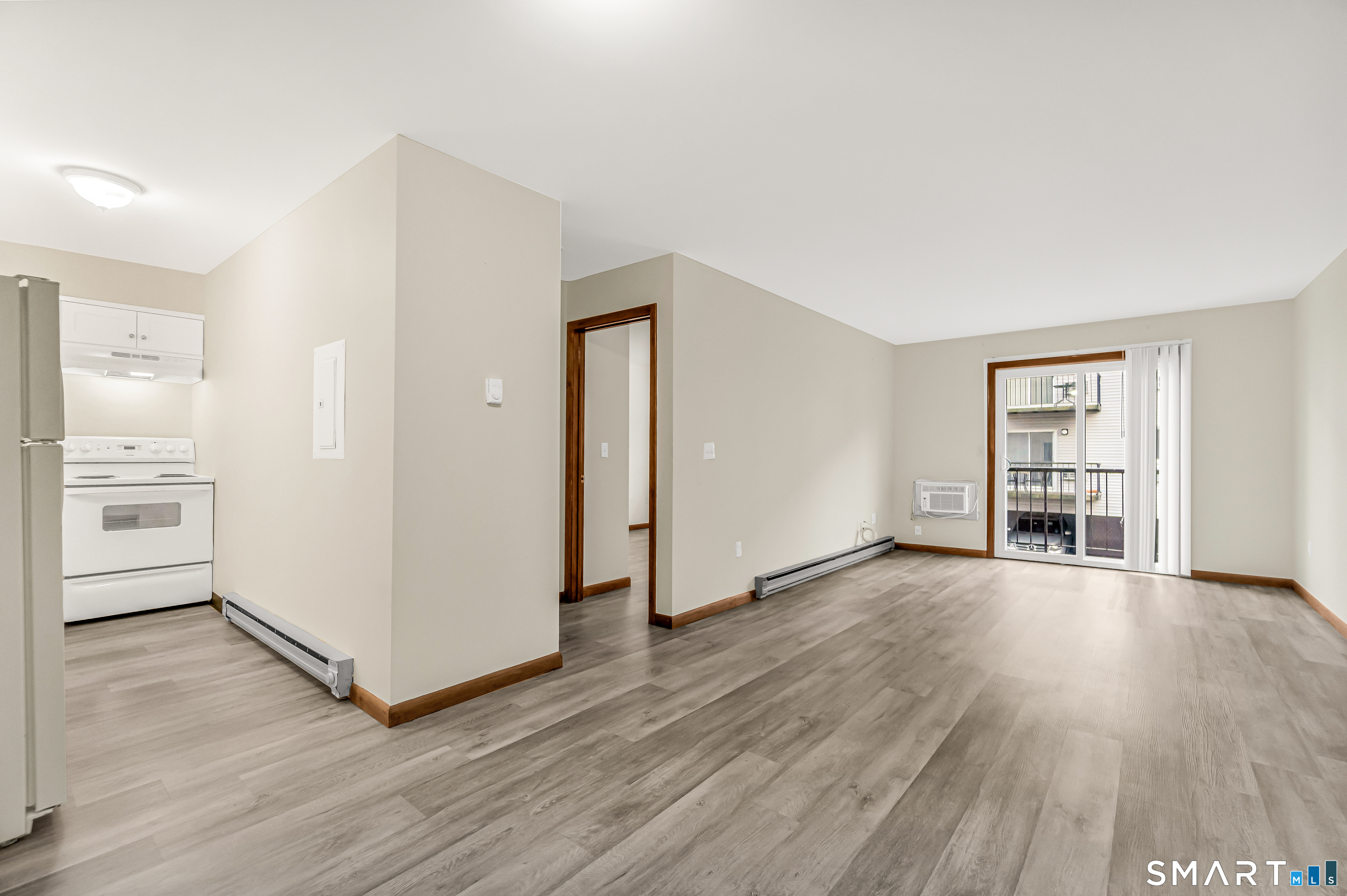 115 Short Beach Road, Unit 103 Stratford, CT 06615 - Photo 4 of 17 an empty room with wooden floor bathroom and windows