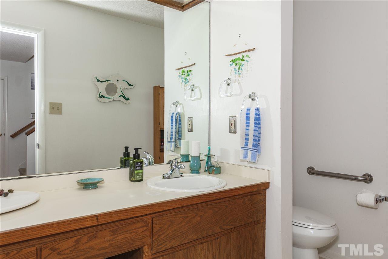 43 Stoneridge Road Durham, NC 27705 - Photo 11 of 24 a bathroom with a granite countertop sink a toilet and a mirror