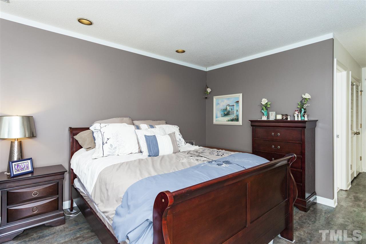 43 Stoneridge Road Durham, NC 27705 - Photo 13 of 24 a bedroom with a bed and a lamp on dresser