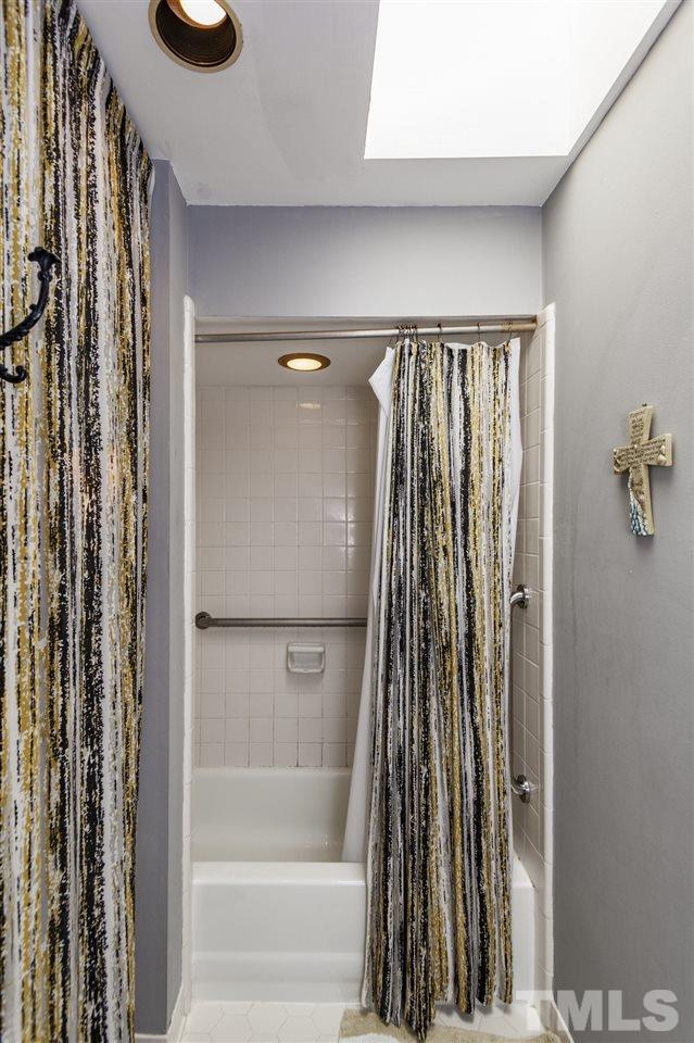 43 Stoneridge Road Durham, NC 27705 - Photo 16 of 24 a view of a bathroom with a tub and a shower curtain