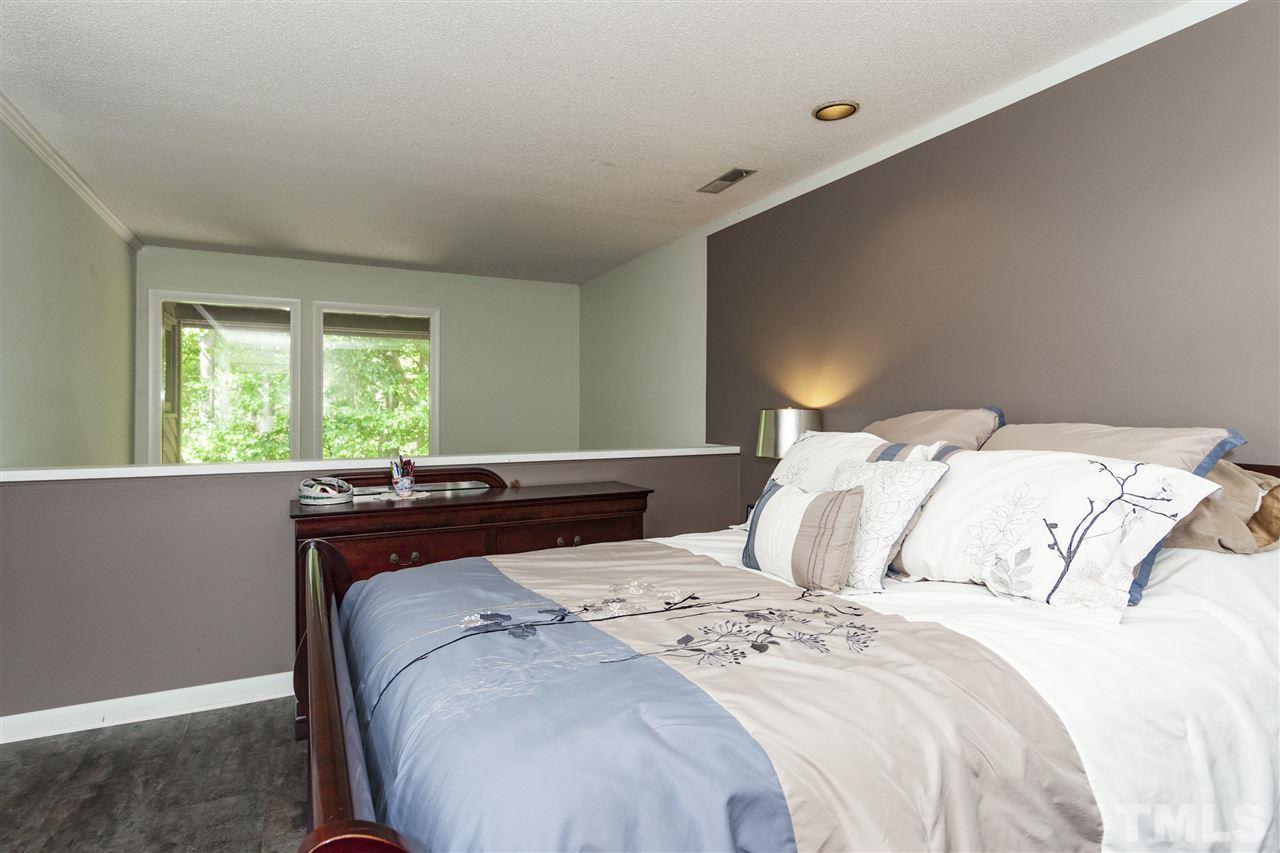 43 Stoneridge Road Durham, NC 27705 - Photo 17 of 24 a bedroom with a bed and a large window