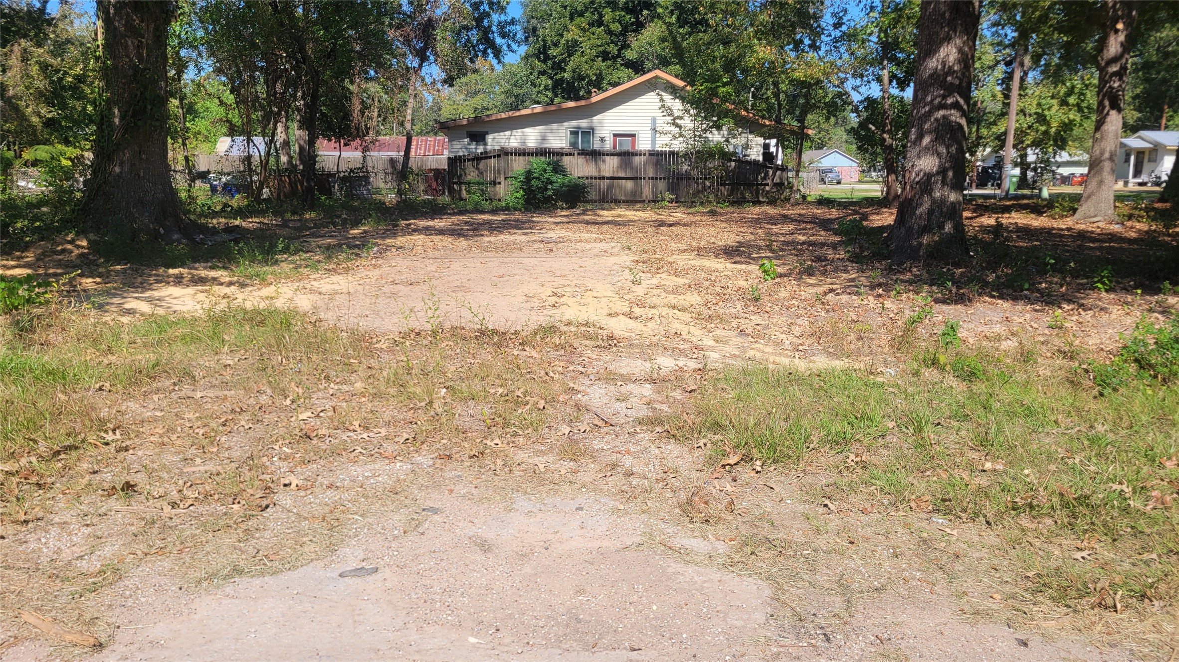 1109 Truman Street Cleveland, TX 77327 - Photo 2 of 4 a front view of a house with a yard covered with snow