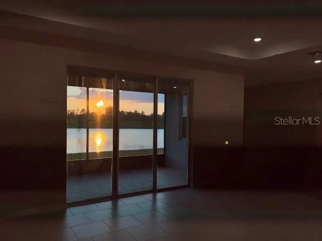 a view of kitchen with stainless steel appliances granite countertop refrigerator and stove